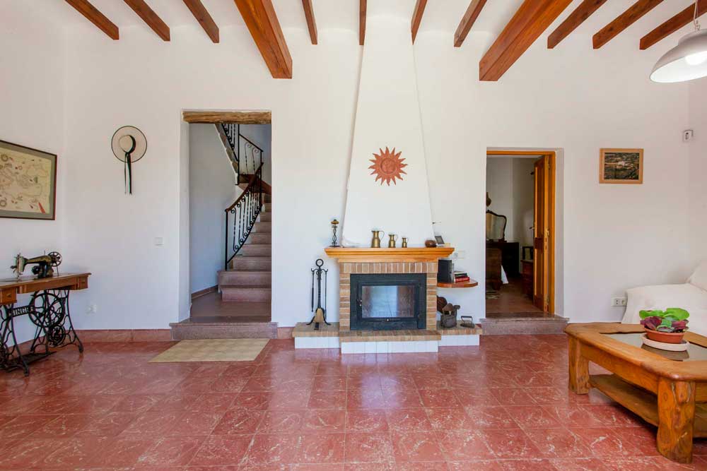 interior living room with fireplace of a rental house in ibiza